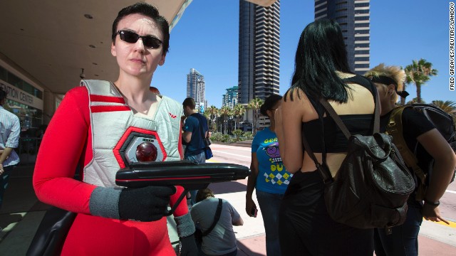 Debbie Moss dressed up as character "Jamie Jaren" from the 1980s animated TV series "Lazer Tag Academy" waits in line hoping to get a volunteer pass.