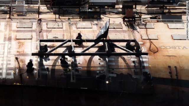 Technicians work to salvage the half-submerged ship on July 7. Nearly 500 workers are involved in an operation to remove the wreck while protecting the marine environment.