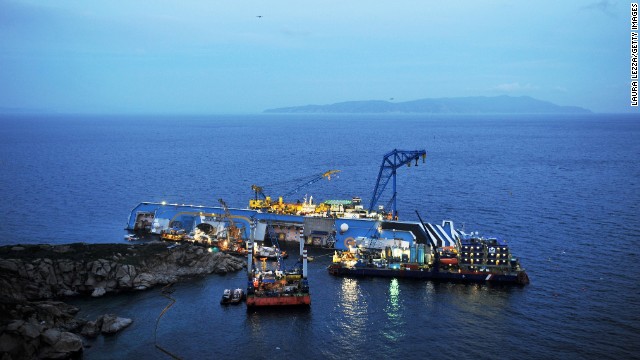 The sunken Costa Concordia remains in the calm blue waters on January 12, 2013, the day before the disaster's one-year anniversary.