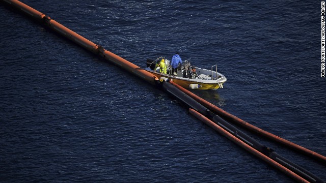 Technicians work during an operation to pump out 2,380 tons of fuel from the stricken ship on January 25, 2012.