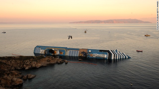 A bird flies overhead the Costa Concordia on January 18, 2012. Rescue operations were suspended as the ship slowly sank farther into the sea.