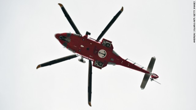 An Italian coast guard helicopter flies over Giglio's harbor on January 16, 2012.