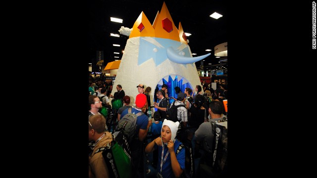 Fans wait to walk through a giant display of Ice King character from "Adventure Time" at the Cartoon Network booth during the Preview Night event.