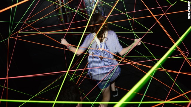 Attendees take part in Adult Swim's Fun House during Comic-Con on July 18.