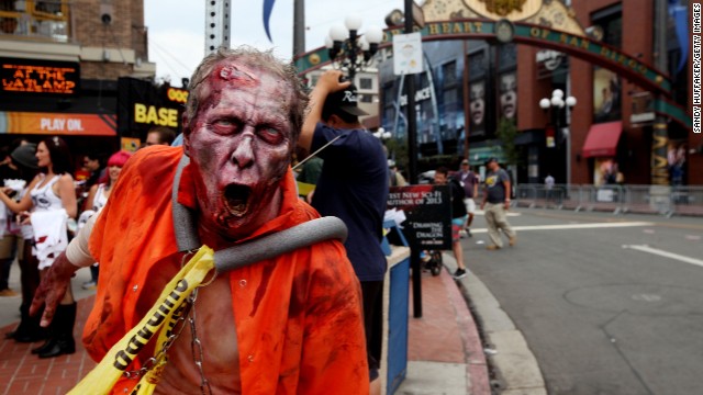 A zombie greets people as along 5th Avenue on July 19, in San Diego's Gaslamp Quarter during the convention.