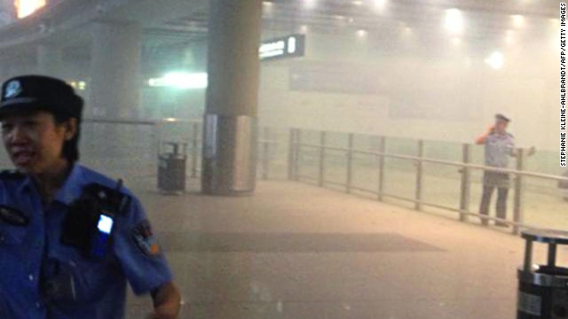 Smoke fills Beijing's airport after a man in a wheelchair ignited a home-made explosive device on July 20.