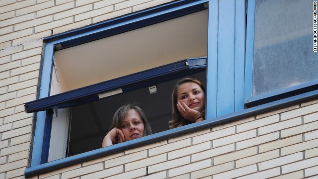 Hospital staff look out over a gathering crowd at St. Mary's Hospital in London on July 22.