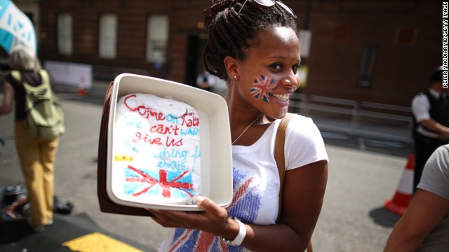 Royal fan Teba Diatta stands outside St. Mary's Hospital with a cake decorated for the occasion on July 22.
