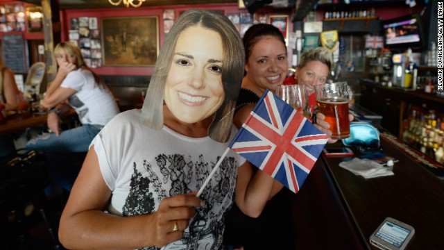 Karen Milne, left, of Scotland wears a mask of Catherine, Duchess of Cambridge, as she and friends celebrate the royal birth at Ye Olde King's Head English Pub in Santa Monica, California, on July 22.