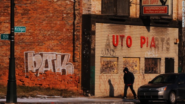 A man walks toward the corner of 15th and Michigan in Detroit.