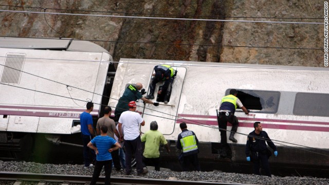 Rescuers work to pull victims from the derailed cars. 