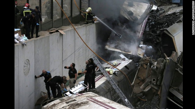 Emergency workers climb on top of the wreckage as they help free injured passengers from the crash. 