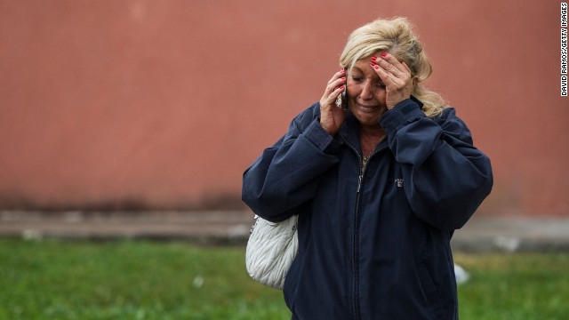 A relative of one of the passengers waits to hear news in Santiago de Compostela as she talks on the phone July 25.