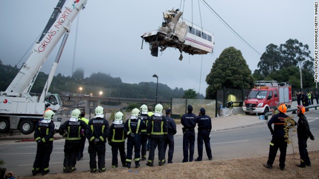 A car from an express train that crashed is lifted Thursday, July 25, at Angrois near Santiago de Compostela, Spain. The train derailed as it hurtled around a curve at high speed on Wednesday, July 24.