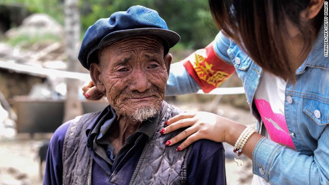 An elderly man weeps on July 24 after he hears he lost his grandson in the earthquake in Yongxing village.