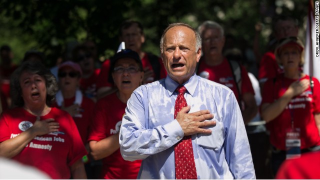 Rep. Steve King, R-Iowa, sings the National Anthem as activists rally against the Senate's immigration legislation. 