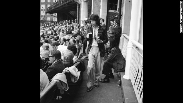 Mick Jagger returns to his seat during a cricket match between England and Australia in 1972.