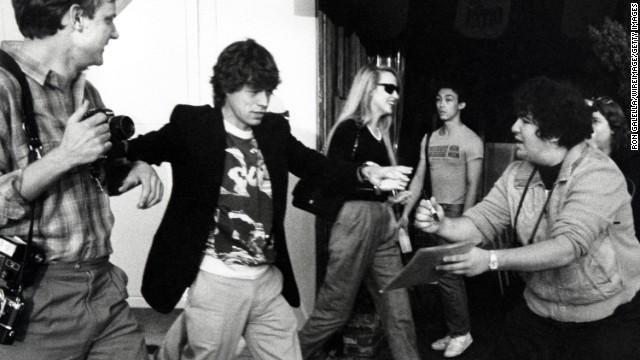 Mick Jagger and then-girlfriend Jerry Hall, center, attend an opening at the Mizuno Gallery in Los Angeles in 1983. Jagger and Hall were married for nine years starting in 1990.