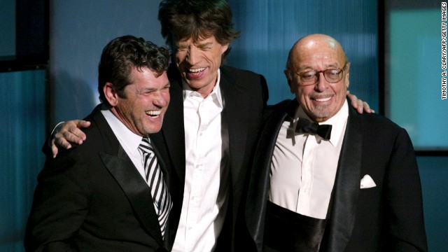 Rolling Stone magazine founder Jann Wenner, left, is presented his award by Mick Jagger and Ahmet Ertegun during the 2004 Rock and Roll Hall of Fame induction ceremony in New York.