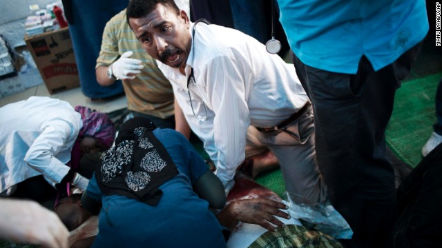 Doctors treat an injured supporter of deposed Egyptian President Mohamed Morsy during clashes with security forces in Cairo on Saturday, July 27. 