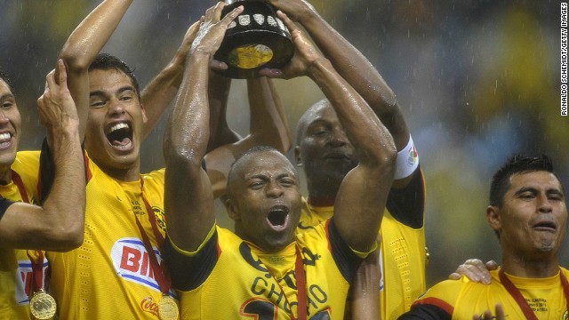 Christian Benitez (C) celebrates with the Mexican Clausura tournament trophy at Azteca stadium in Mexico City on May 26.