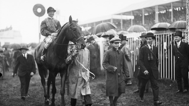 Britain's royals have strong links to racing. A horse owned by King George V is escorted home after winning the Steward's Cup at Royal Ascot in 1911.