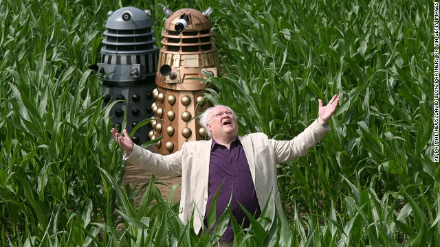 Colin Baker, who played the sixth Doctor from 1984-1986, poses with robotic creatures called Daleks in a field picturing the largest image of a Dalek on July 12, 2013 in York, United Kingdom.