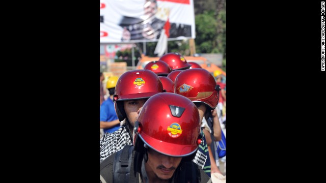 Morsy supporters in red helmets march during a protest against the government in Cairo on August 2. Pro-Morsy marches began after Friday prayers, when supporters made their way back to their camp outside the Rabaa al-Adawiya mosque. 