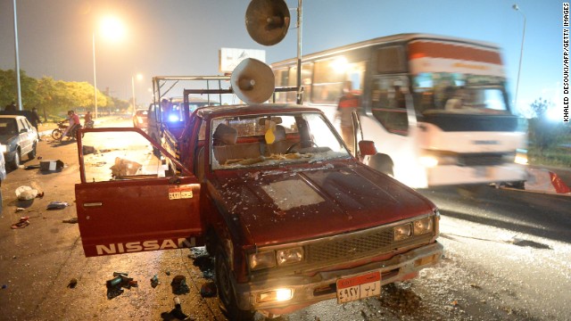 A bus passes a destroyed pickup truck with loudspeakers that was used by supporters of ousted Egyptian President Mohamed Morsy on Friday, August 2. The supporters and security forces clashed in Sixth of October City in Giza, south of Cairo, after the government ordered their protest camps be broken up. <a href='http://www.cnn.com/2013/08/15/middleeast/gallery/egypt-violence-august/index.html' target='_blank'>Look at the latest violence in Egypt.</a>