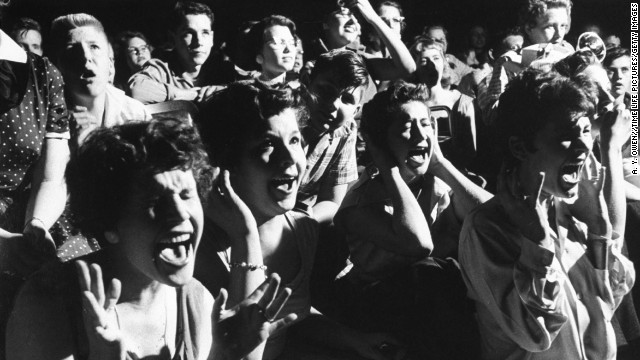 Screaming teenage girls watching Elvis in concert.