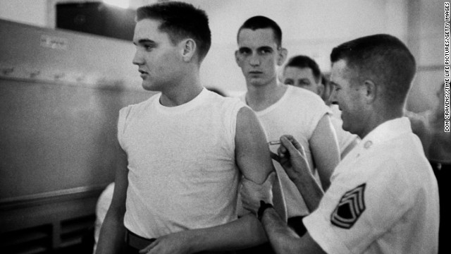 U.S. Army Pvt. Elvis Presley gets a shot from at his pre-induction physical at Kennedy Veterans Hospital on March 26, 1958.