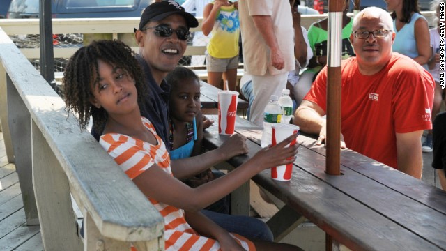 The president waits for lunch with daughters, Malia, left, and Sasha, at Nancy's restaurant on August 26, 2009.