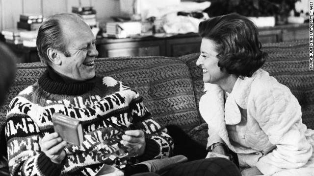 President Gerald Ford opens a gift from his wife, Betty Ford, during their usual Christmas holiday vacation spot in Vail, Colorado, December 1974. 