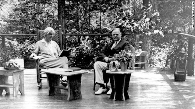 President Herbert Hoover and Lou Henry Hoover sit on the porch of their Radipan Camp retreat, now part of the Shenandoah National Park, in Virginia. The president originally bought the land for the vacation spot in 1929. 