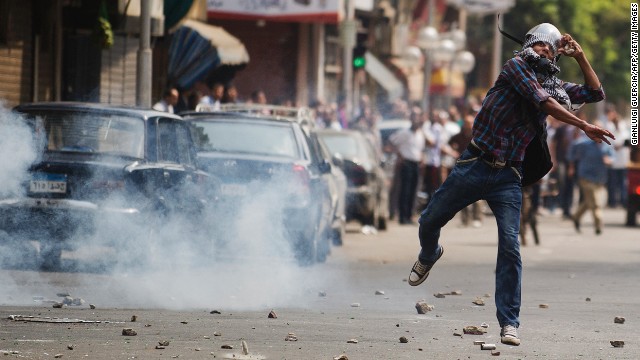 Police fire tear gas as supporters of ousted Pres. Mohamed Morsy clash with residents and police in Cairo on August 13, 2013.