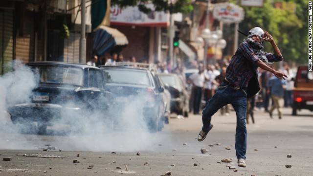 Egyptian riot police fire tear gas as supporters of ousted president Mohamed Morsy clash with police in Cairo, August 13, 2013.