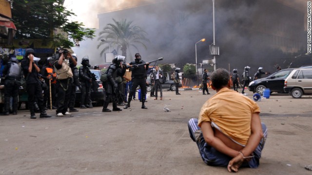 A Morsy supporter sits under arrest at Cairo's Nahda Square on August 14.