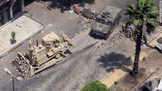 Army bulldozers remove a barricade erected by supporters of Morsy during clashes with riot police at Cairo's Mustafa Mahmoud Square on August 14.