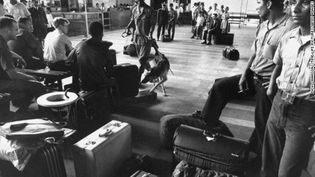 Police dogs trained to smell out hidden marijuana examine U.S. soldiers' luggage at the airport during the Vietnam War in 1969. Drug use was widespread during the war.