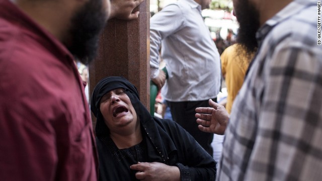 A woman weeps after identifying the body of a relative on August 15 at a Cairo mosque.