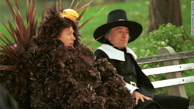 Billy Crystal, left, dressed as a turkey, sits on a bench with De Niro, dressed as a pilgrim, during the filming of a Thanksgiving-themed "I Love New York" commercial in 2001.