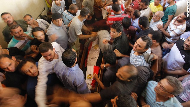 A flag-covered coffin of a man killed during Wednesday's clashes is carried at Amr Ibn Al-As Mosque before a funeral in Cairo on August 16.