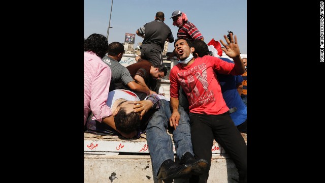 Demonstrators hurt in the clashes at Ramses Square are taken away on August 16 in Cairo.