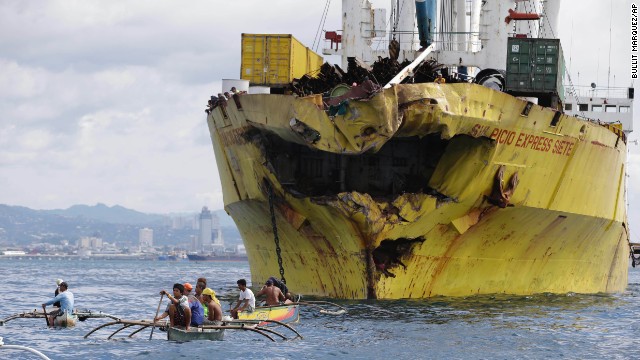 Volunteers search for victims near the damaged cargo ship Sulpicio Express Siete on Saturday, August 17, a day after it collided with a passenger ferry in Talisay, in the Cebu province of the Philippines. The ferry, which sank, is thought to have been carrying about 700 passengers.