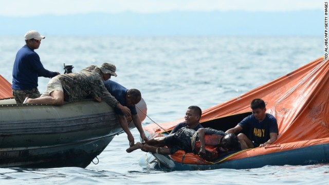 Philippine Navy personnel lift a victim from one of the floating life rafts during rescue operations on August 17. The two ships collided around 9 p.m. Friday.