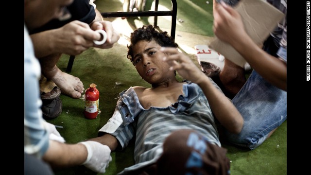 A wounded boy is treated in the Taamin Sehi field hospital during clashes on August 16.