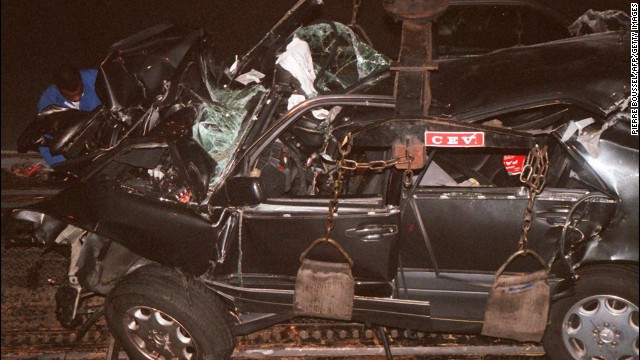 A French police expert can be seen in the background working on the wreckage in the tunnel where they crashed.