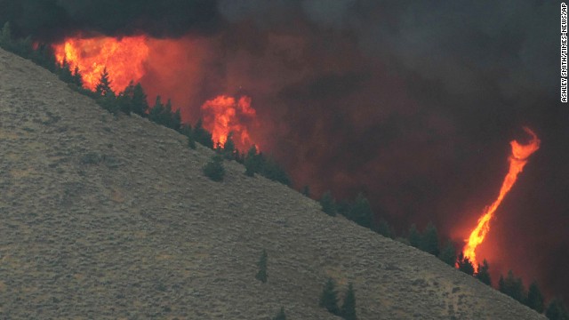 A fire "whirl" can be seen as erratic wind conditions stir the flames of the fire on August 16. 