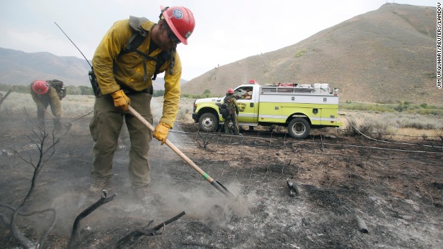 Firefighters clear an area burned by the Beaver Creek Fire on August 17. Approximately 1,200 firefighters are working the blaze, with the help of helicopters, bulldozers and conventional engines.