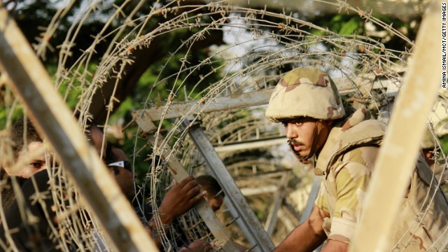 A soldier sets up barbed wire in anticipation of protesters outside the constitutional court in Cairo on Sunday, August 18. The protesters never showed up. Over the past week, about 900 people -- security forces as well as citizens -- have been killed. Deaths occurred when the military used force to clear supporters of ousted President Mohamed Morsy from two sit-in sites in Cairo on Wednesday, and violence raged after Morsy supporters staged demonstrations Friday. Look back at Egypt's unrest.